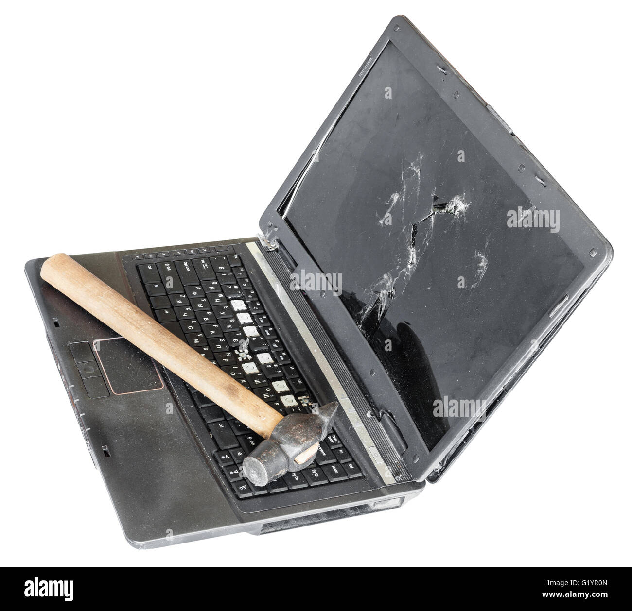 old broken laptop with hammer on keyboard isolated on white background Stock Photo