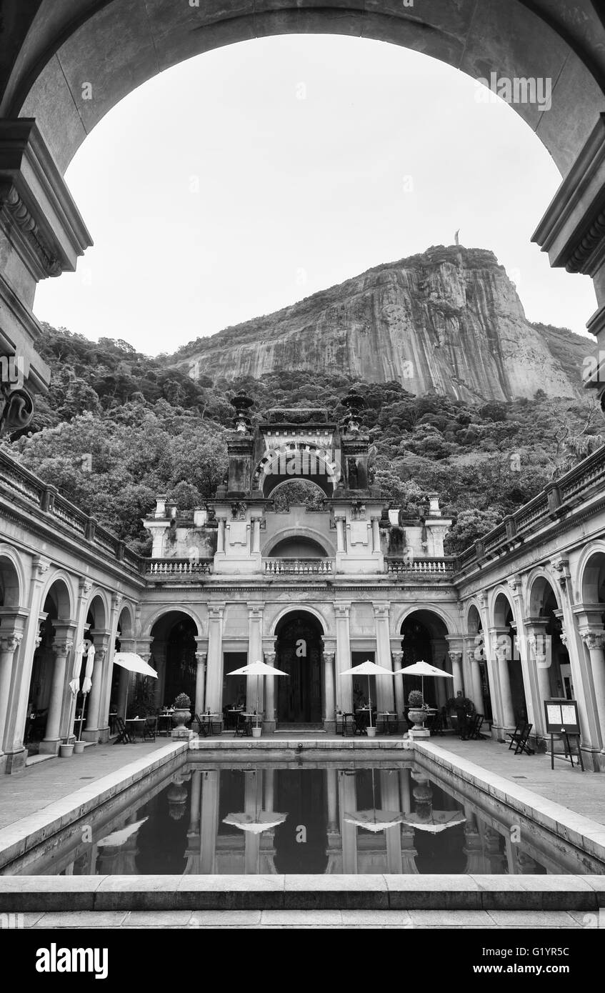 RIO DE JANEIRO - MARCH 3, 2016: Corcovado Mountain stands above weathered colonial architecture of the public Parque Lage. Stock Photo