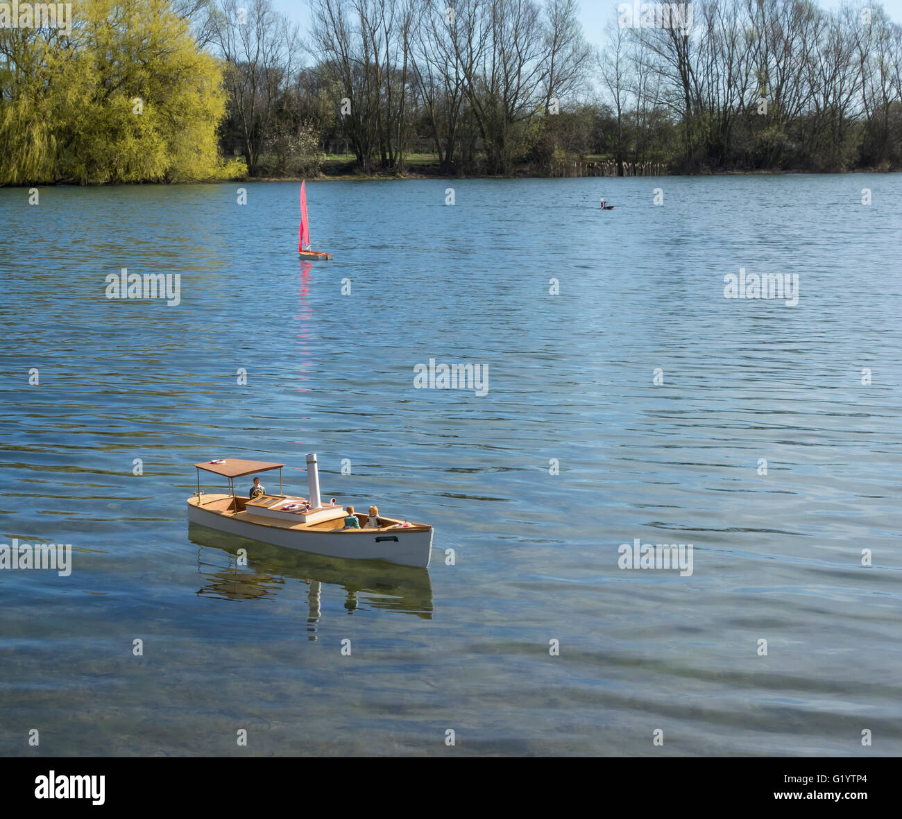 Model of a Victorian lake steam launch 'Milton Maid' Powered by electric motor sailing on Cawcutts lake Cambridge England Stock Photo