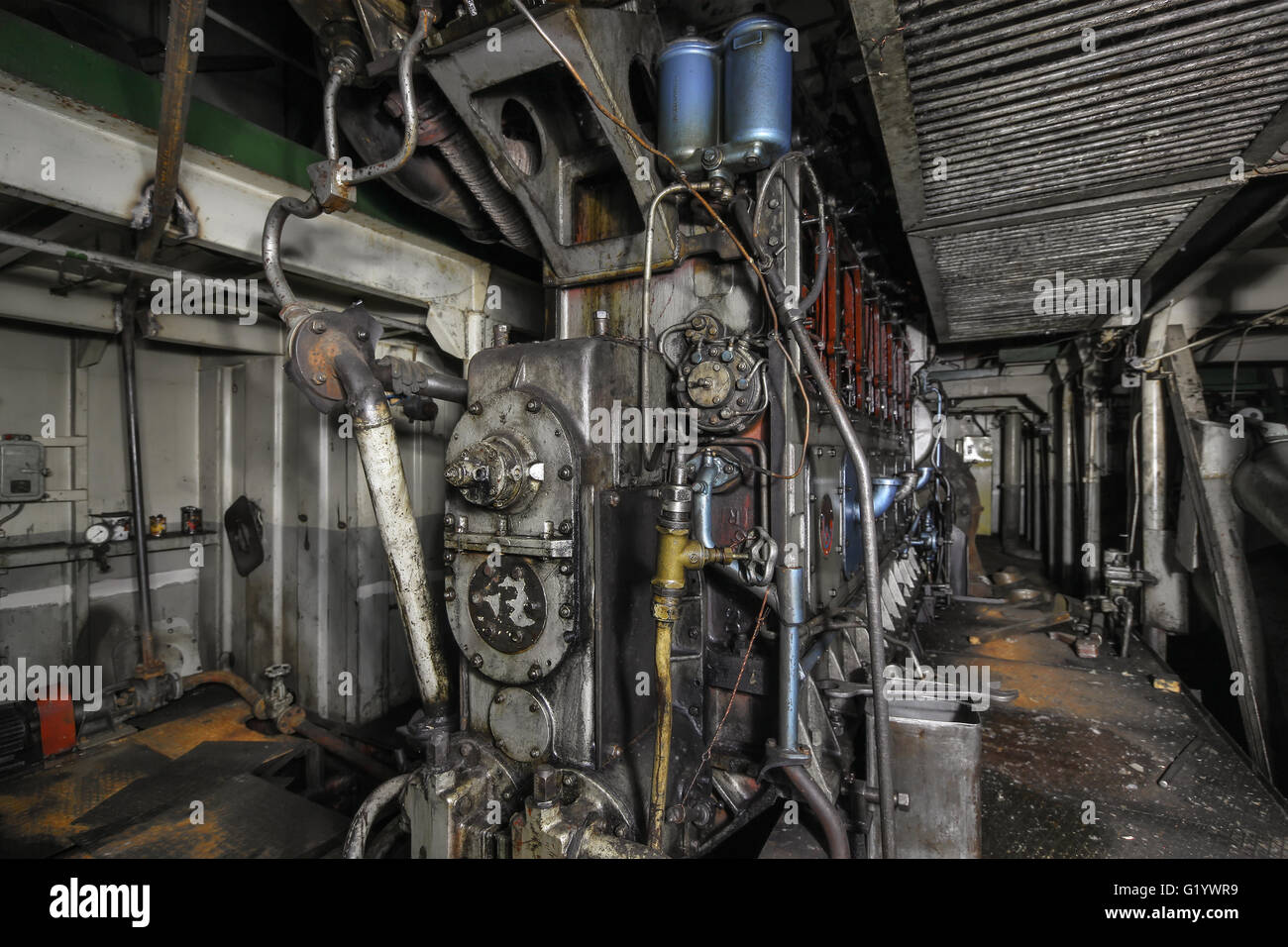 The ship's hold with diesel engine mounted on ship. Engine room on a old cargo boat ship. Focus, on, the, center, of, frame Stock Photo