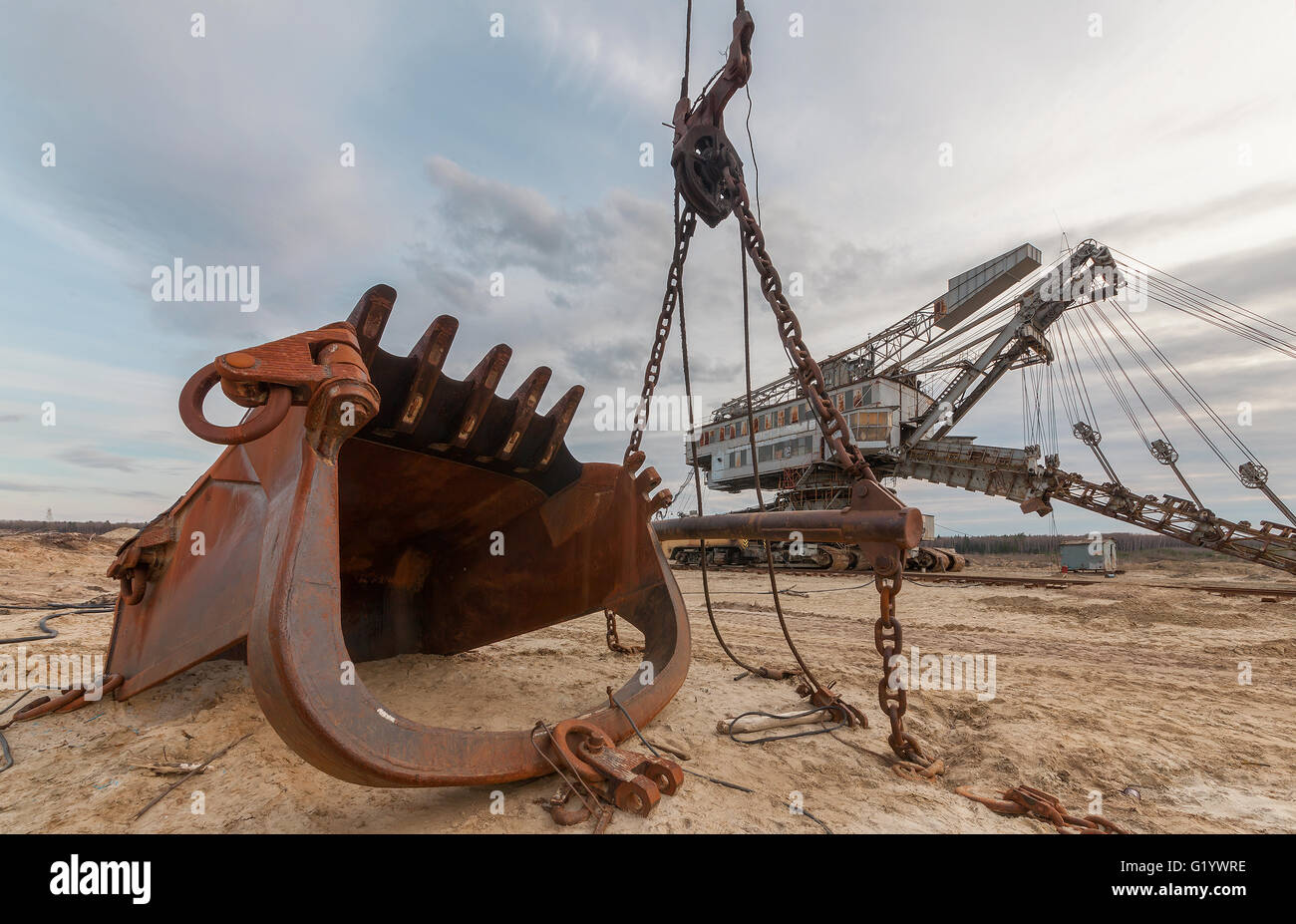 A giant rusty bucket in the background quarry excavator Equipment for the extraction of sand from the quarry. Stock Photo
