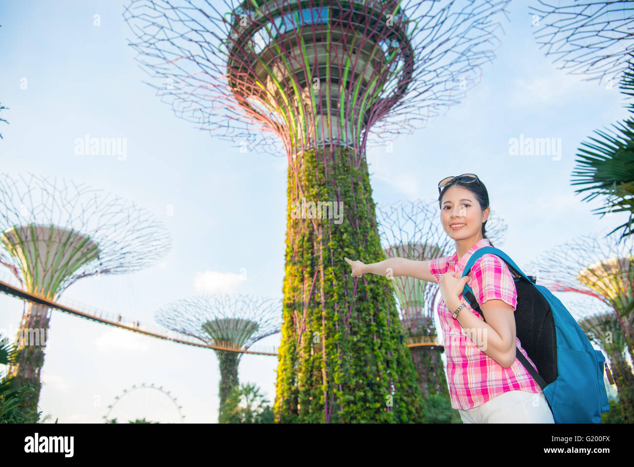 Happy Asia woman Travel in Singapore, Pointing Super Trees Stock Photo