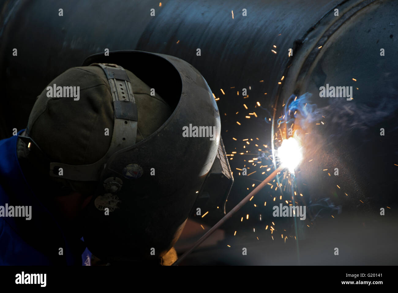 A Con Ed welder welding a gas pipe in Greenwich Village, New York City