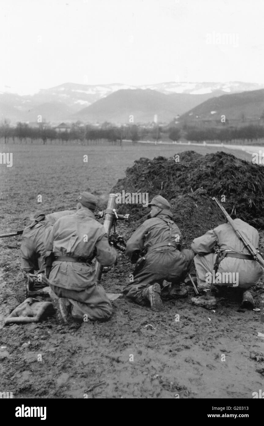 German Mortar with Crew prepare to fire on village Balkans Yugoslavia  1944 Stock Photo