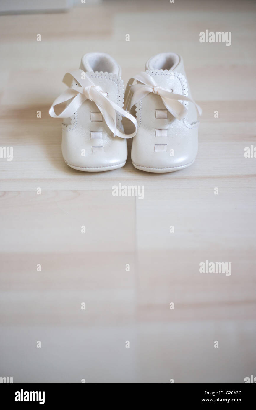 White vintage shoes for a little baby girl Stock Photo