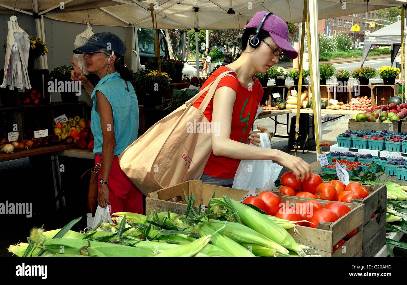 NYC:  Asian woman shopping for farm-fresh tomatoes at the 114th Street farmers market on Broadway at Columbia University Stock Photo