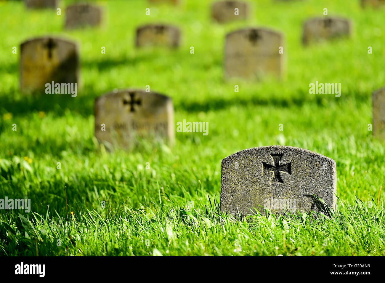 Gravestone of a unknown german soldier with the iron cross symbol in a heroes graveyard Stock Photo