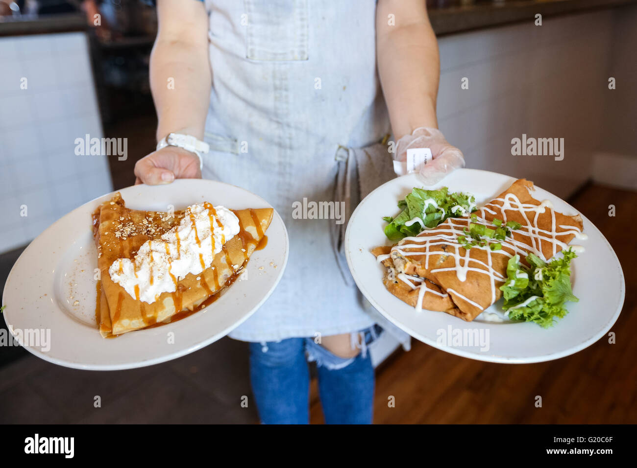 A server shows of freshly made crepes at the Tandem Creperie and