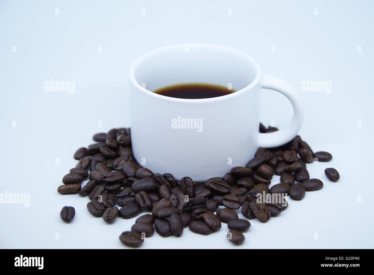 A cup of coffee decorated with coffee beans Stock Photo