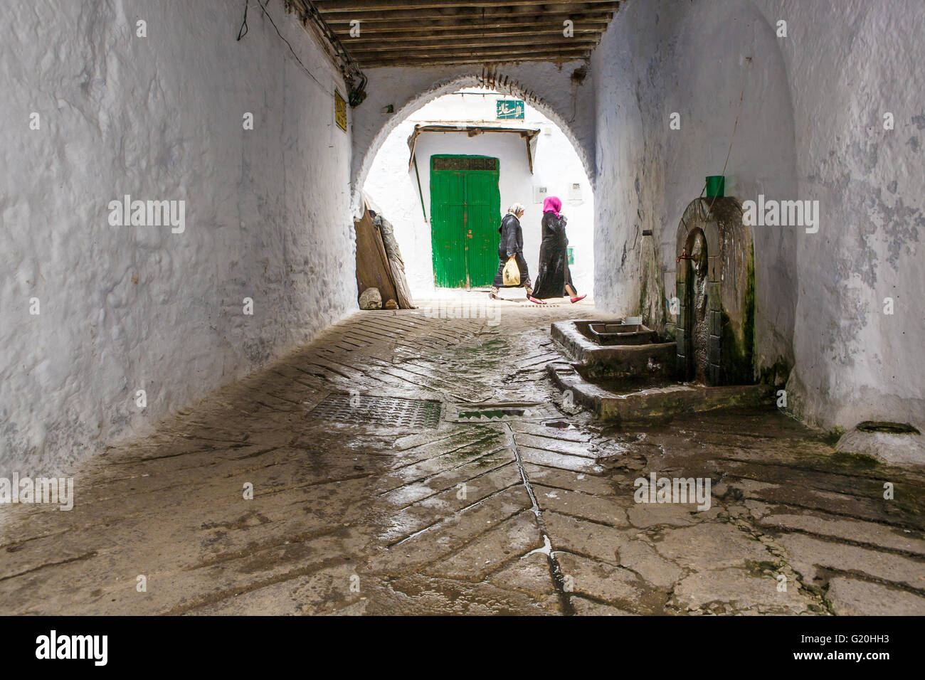 TETOUAN, MOROCCO - AUGUST 17: Unidentified arabic women walking by whitewashed streets of the medieval medina, on August 17, 201 Stock Photo