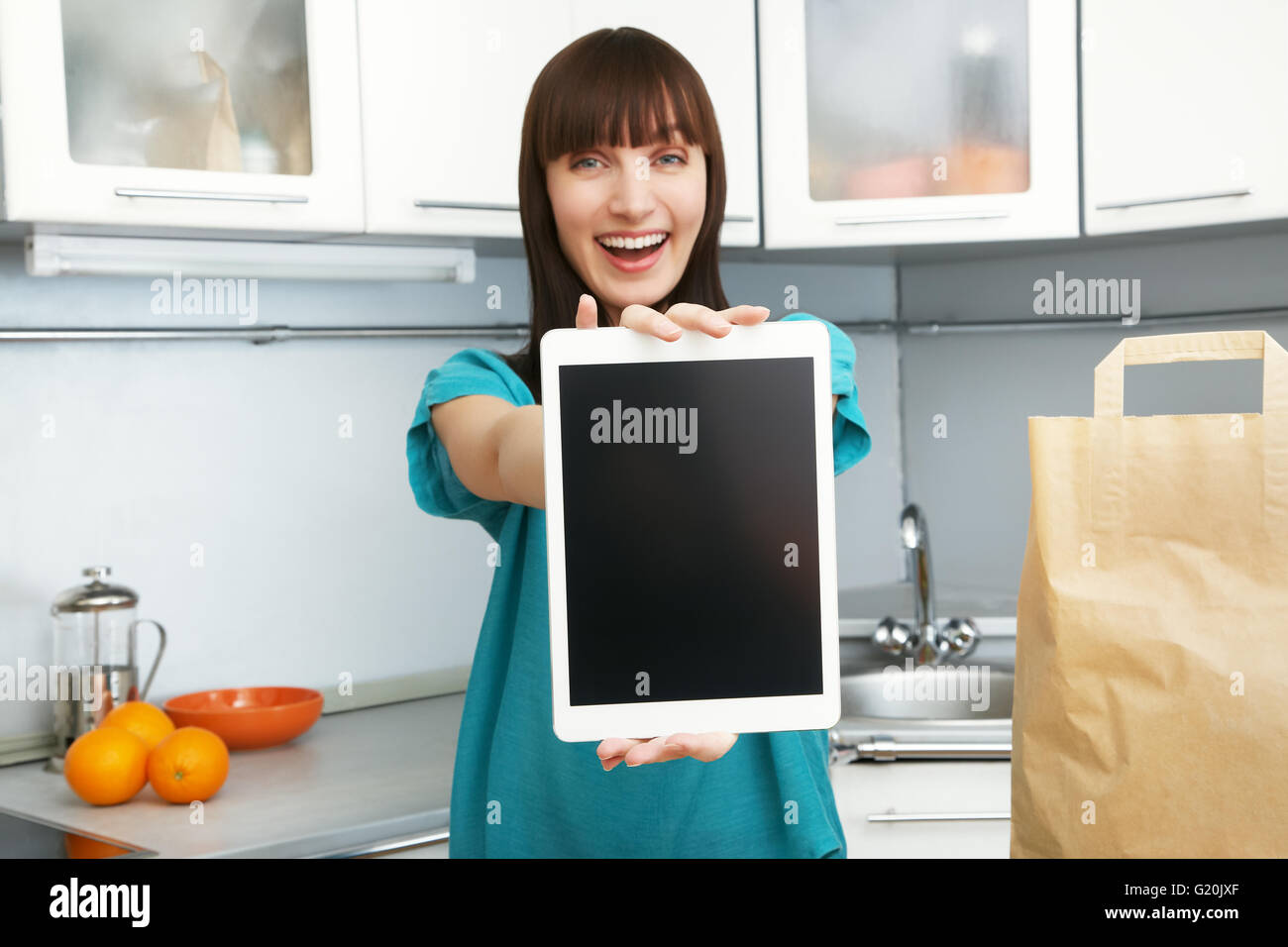 housewife uses a tablet computer in the kitchen Stock Photo Alamy