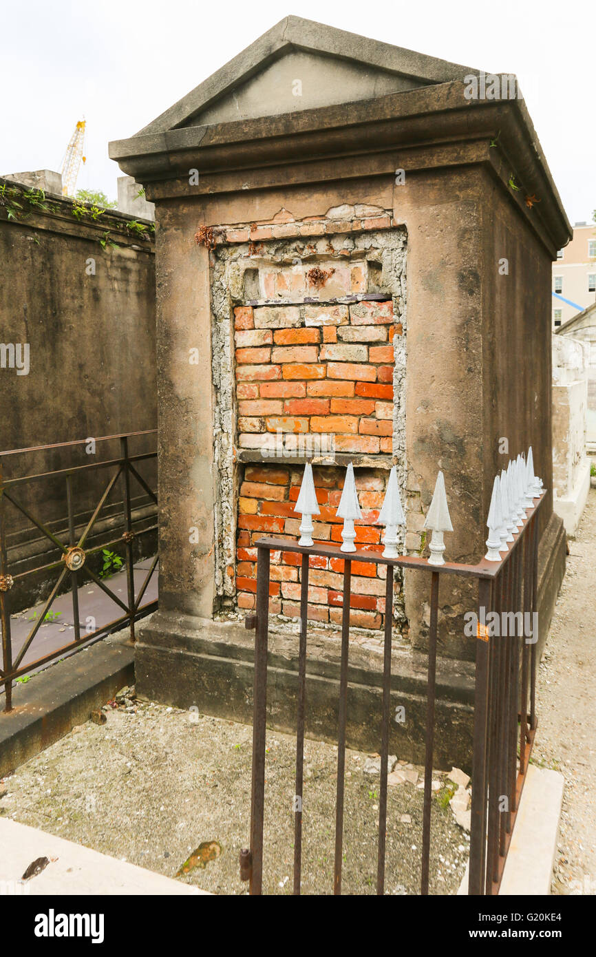 old brick, stone and plaster tomb with wrought iron gate in New Orleans Stock Photo