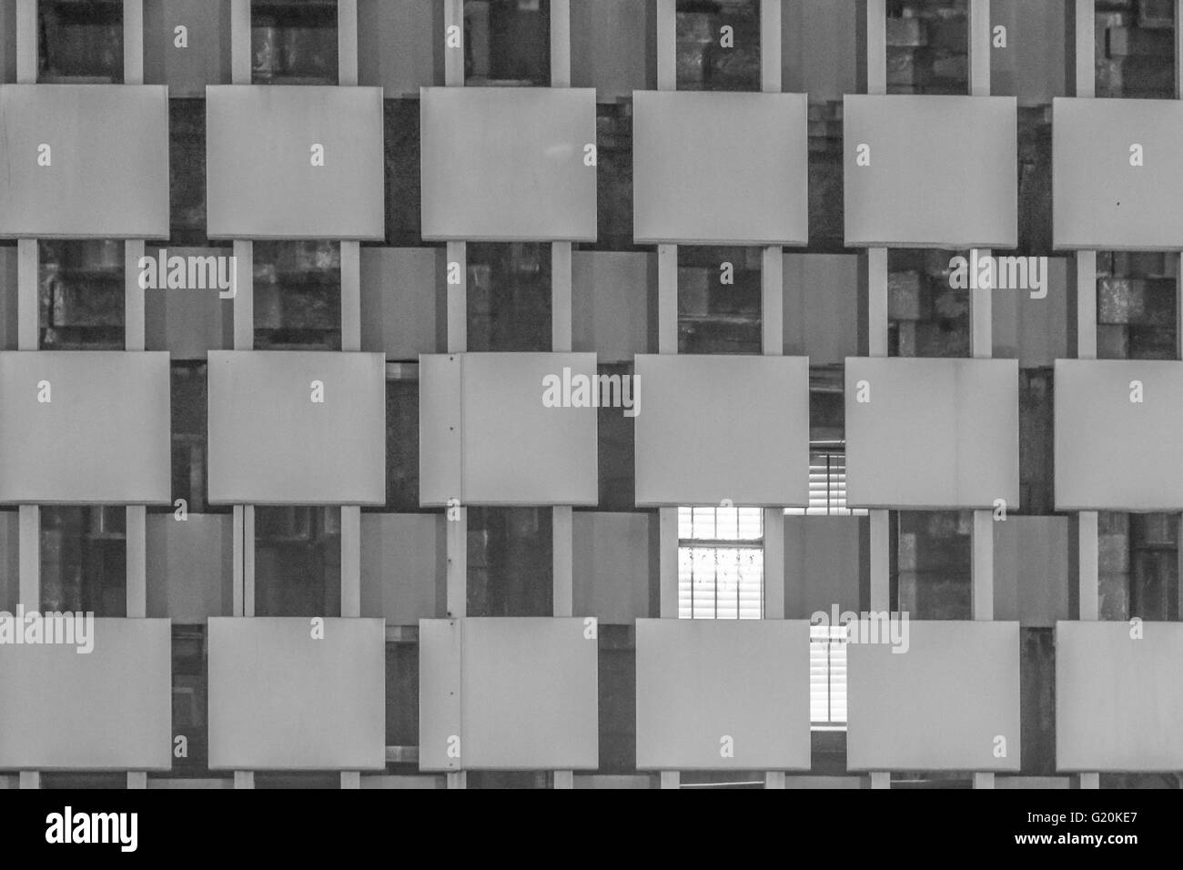 black and white image of the facade of a building that has a grid like pattern in New Orleans, LA Stock Photo