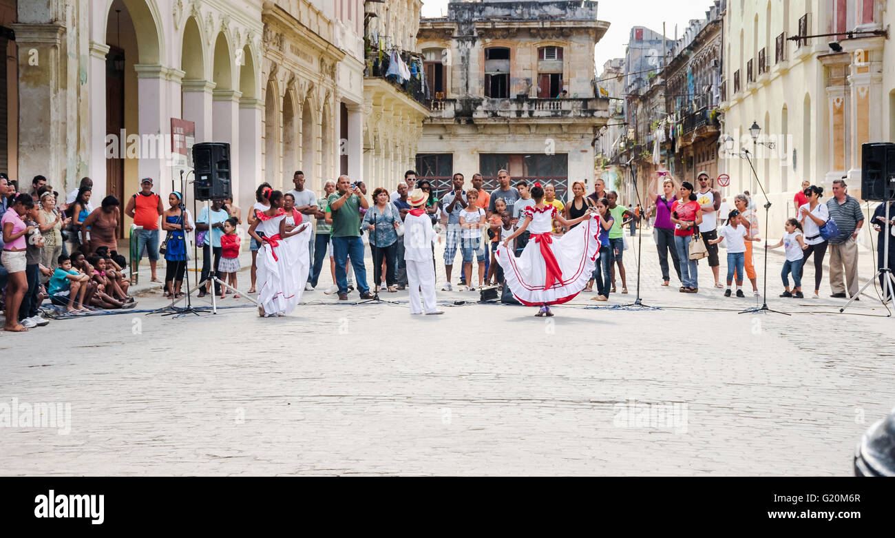 HAVANA, CUBA - JANUARY 1, 2013 Local kids in traditional outfits perform dancing and singing on street in Old Havana, Cuba. Stock Photo
