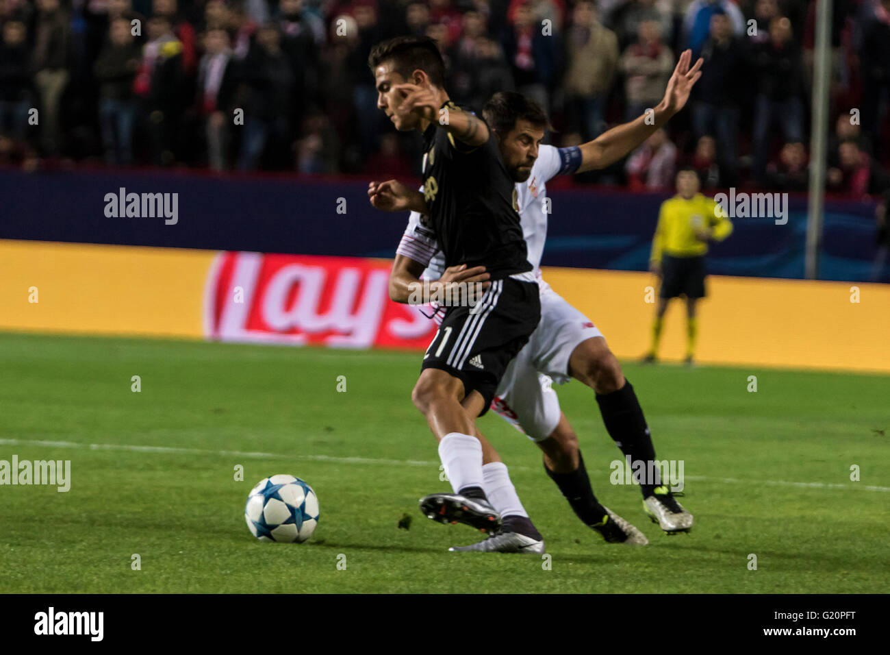 Paulo Dybala of Juventus (L ) and Coke of Sevilla (R ) fight for the ball during the UEFA Champions League Group D soccer match between Sevilla FC and Juventus at Estadio Ramon Sanchez Pizjuan in Sevilla, Spain, 8 December, 2015 Stock Photo