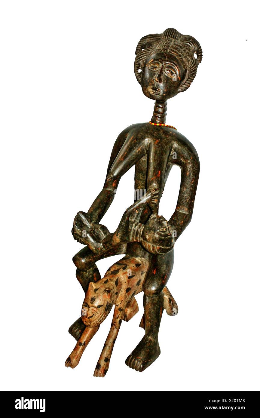 Tribal wooden figure of a women riding or sitting on a Leopard, hand caved by tribes from West Africa Stock Photo