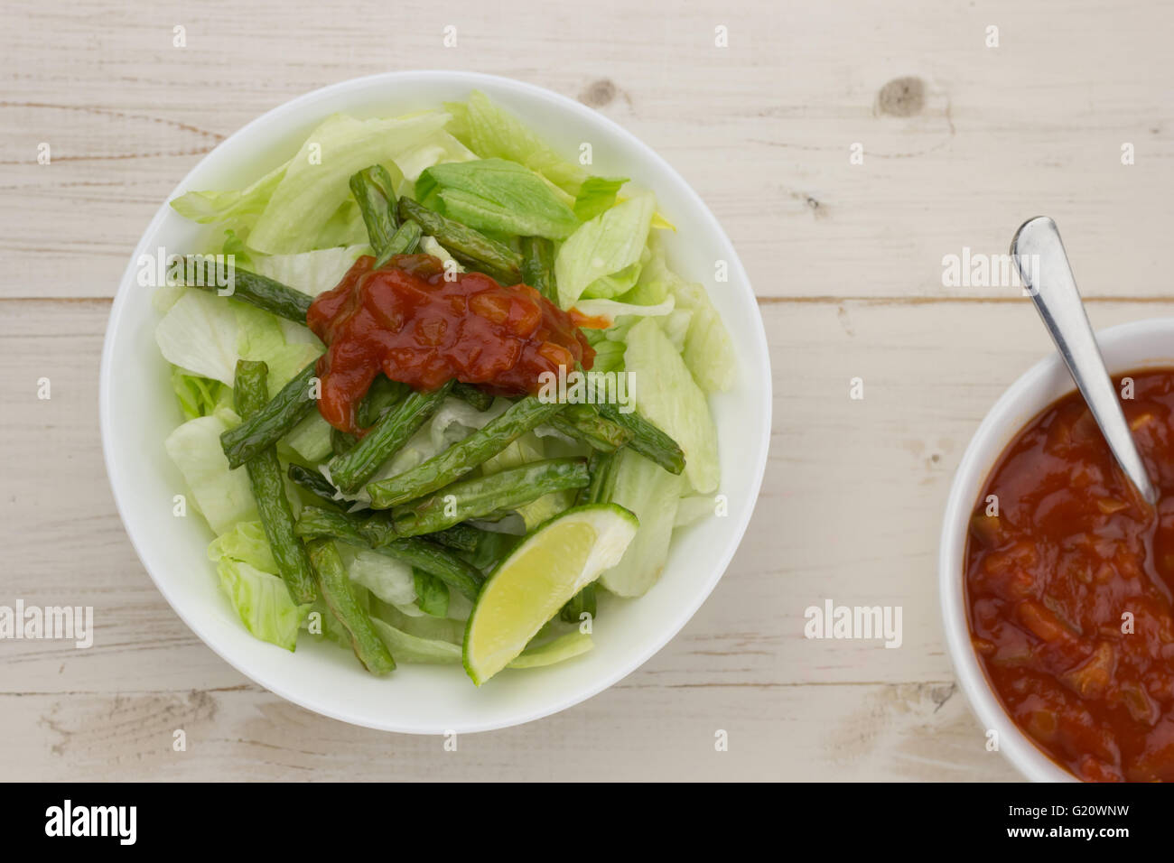 Simple mexican salad with grilled green beans ans red salsa Stock Photo