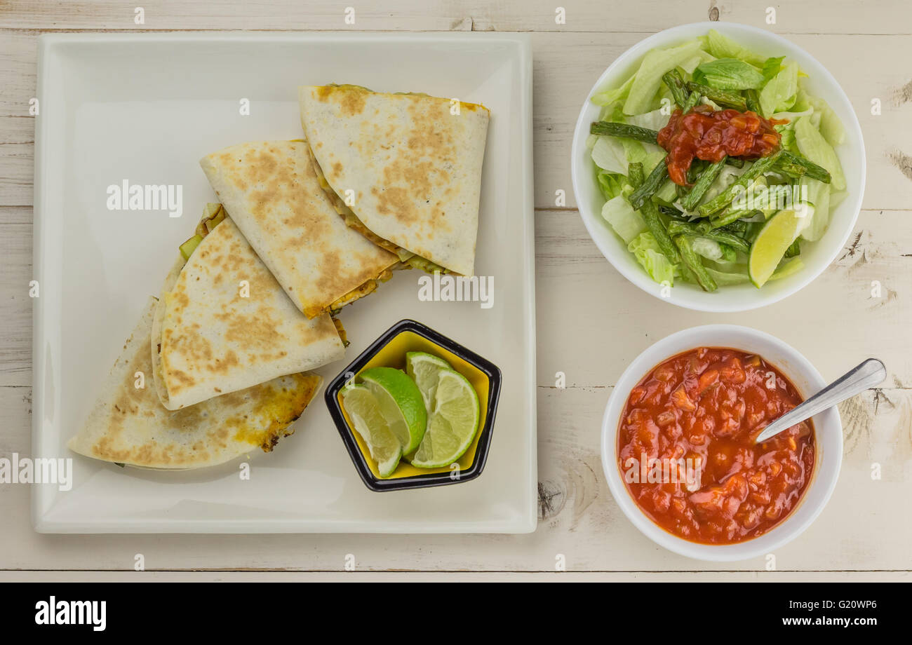Mexican quesadillas with chicken, green beans salad and salsa Stock Photo