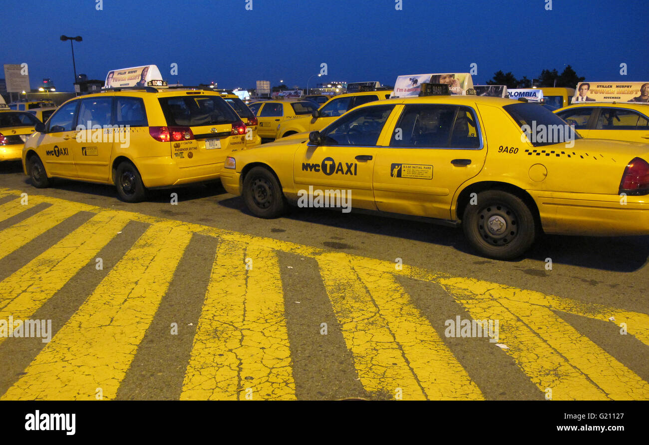 yellow cabs waiting in line at JFK' s Central Holding Lot waiting for their turn to go to terminals to pick up passengers Stock Photo