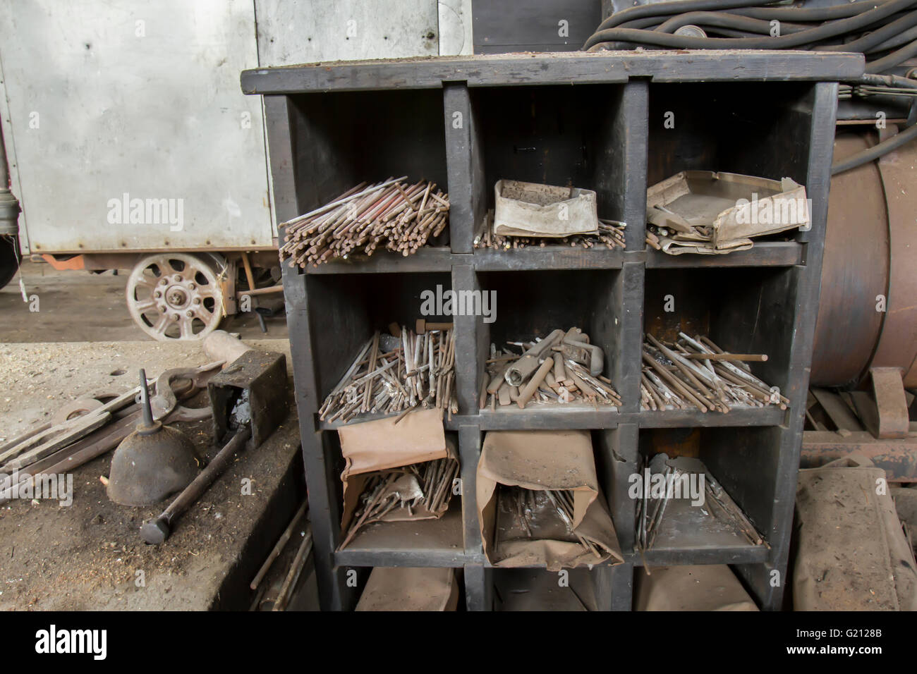 Welding supplies in old railroad machinery shop. Stock Photo