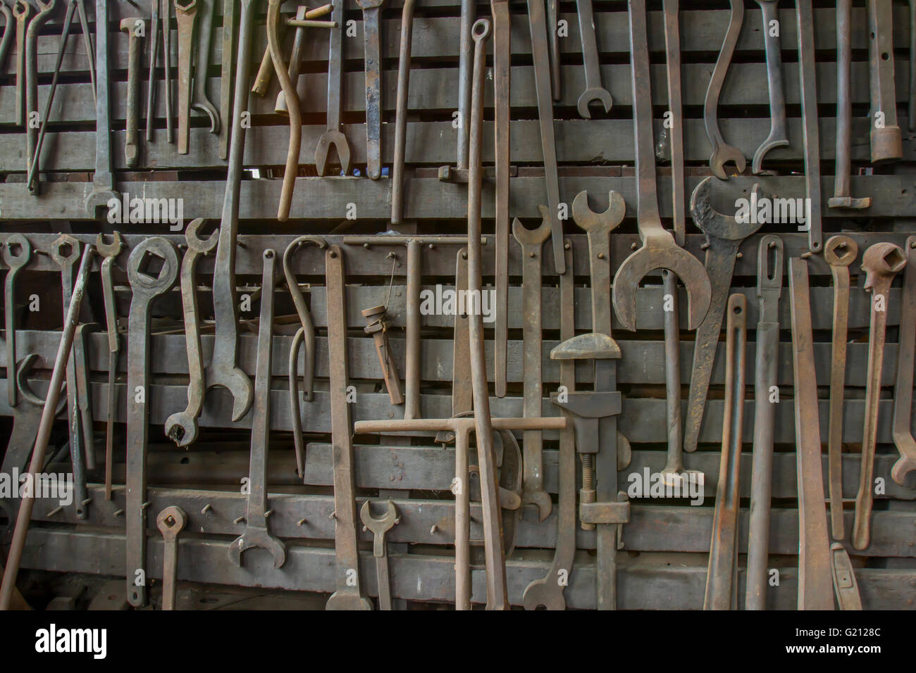 Wooden rack filled with vintage, rusting wrenches Stock Photo - Alamy