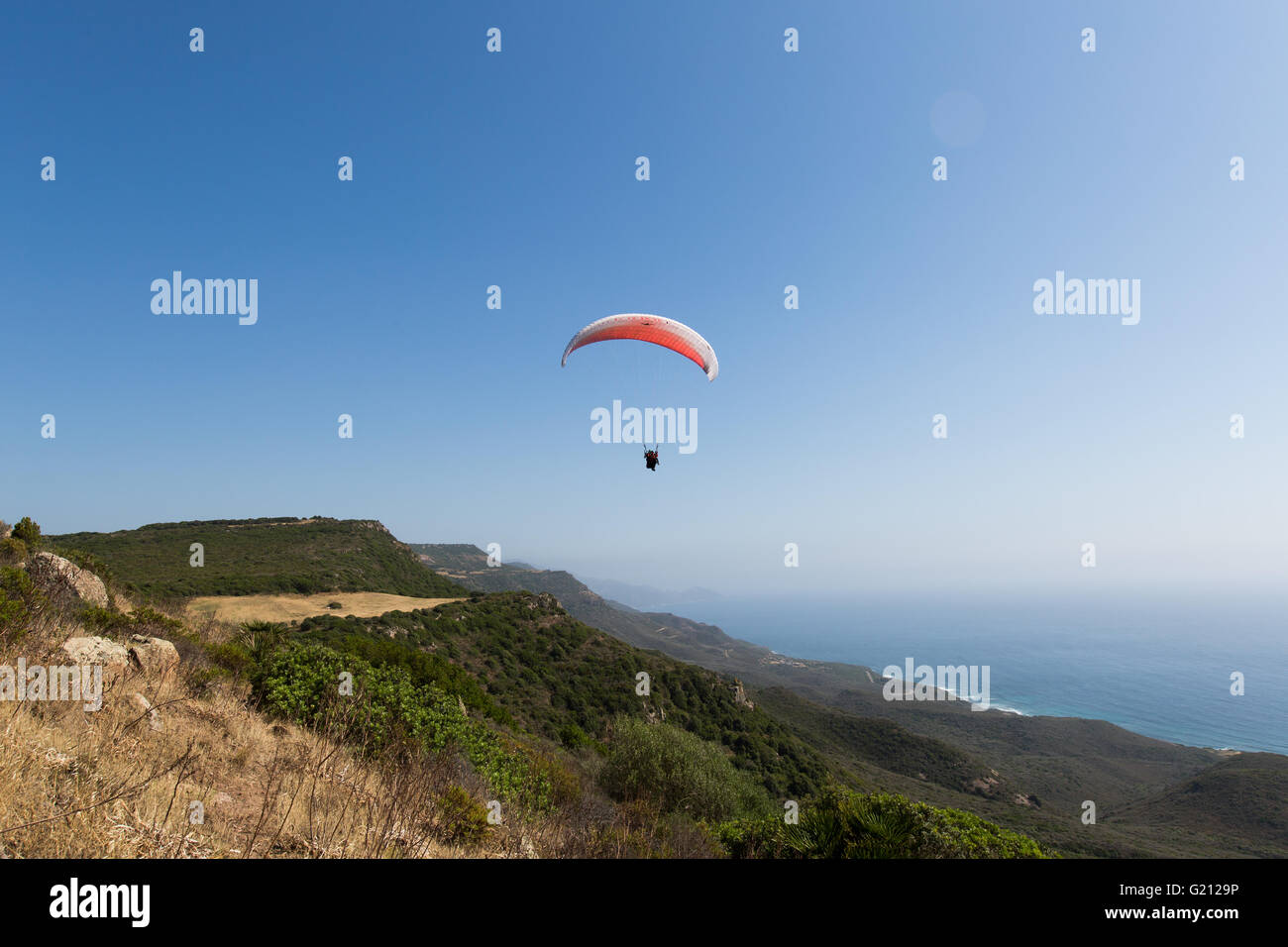 Paragliding over mountains in Italy Stock Photo