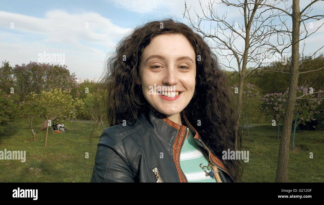 Pretty brunette long hair girl portrait outdoors Stock Photo - Alamy