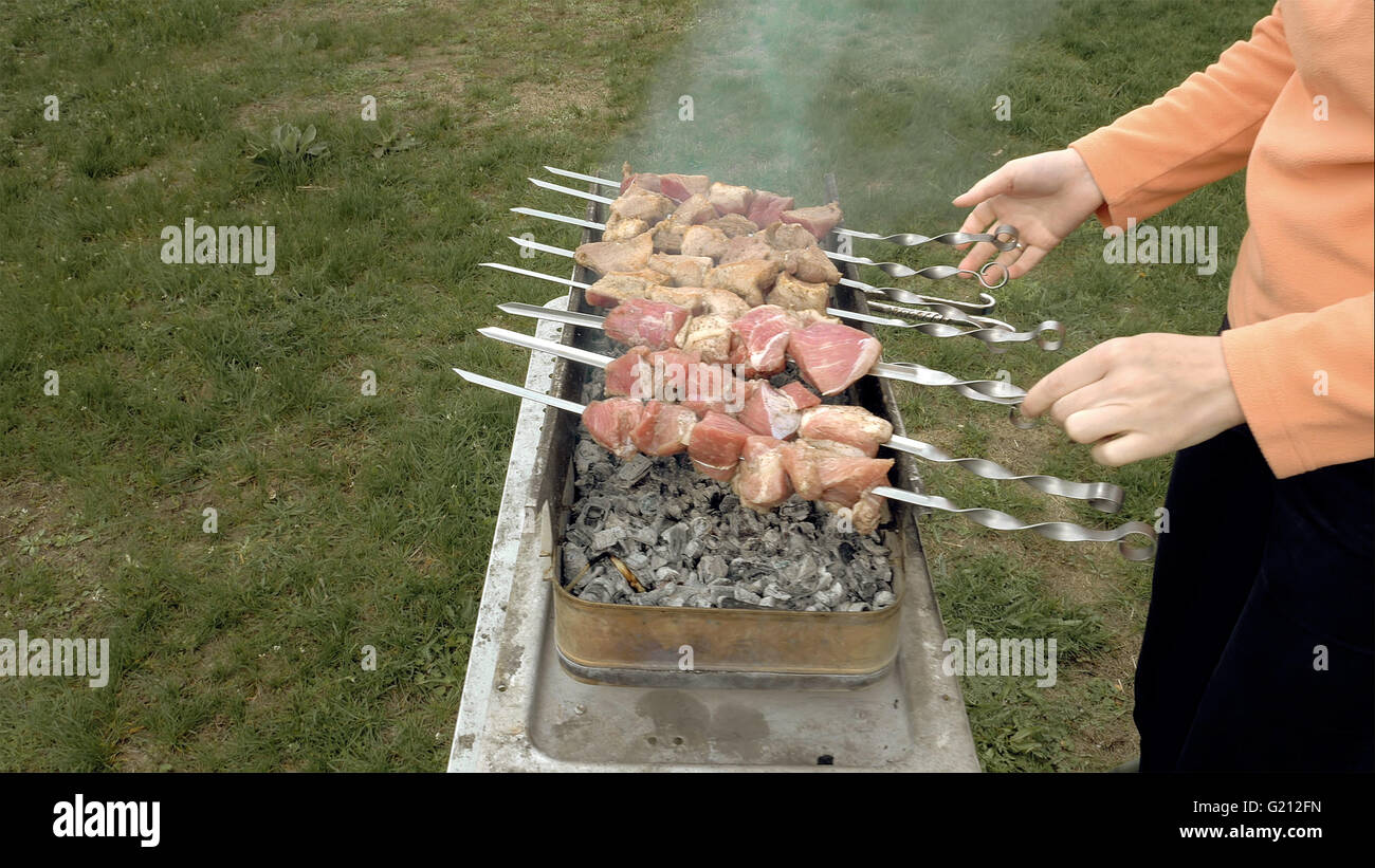 Barbeque skewers with meat cooking on brazier Stock Photo