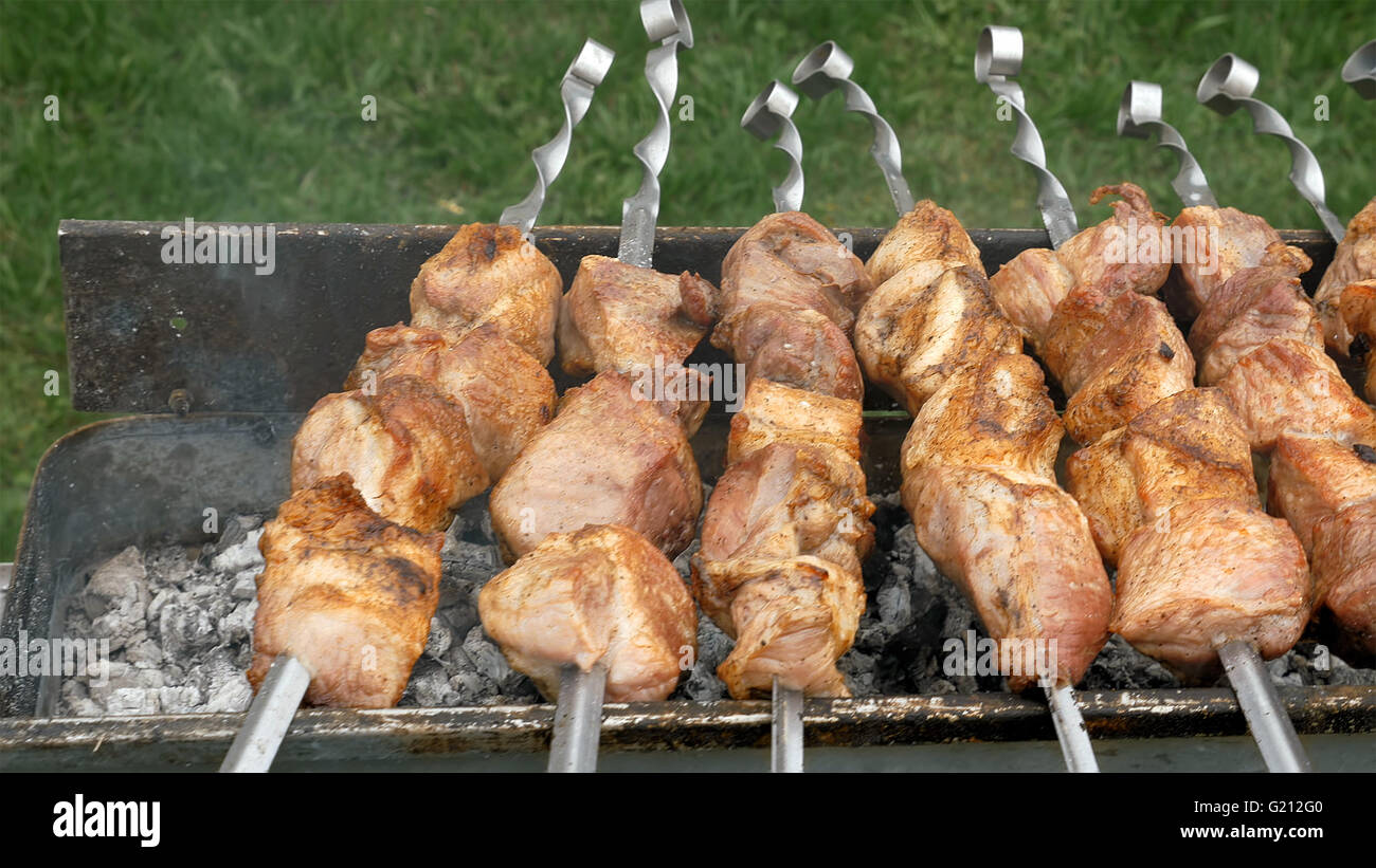 Barbeque skewers with meat cooking on brazier Stock Photo
