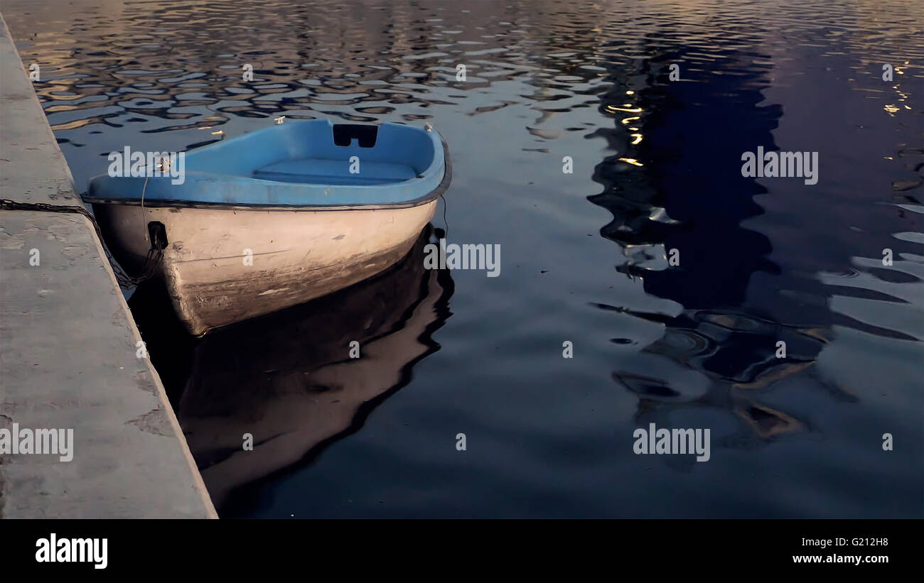 Boat on the water in the quay moorage at sunset Stock Photo - Alamy