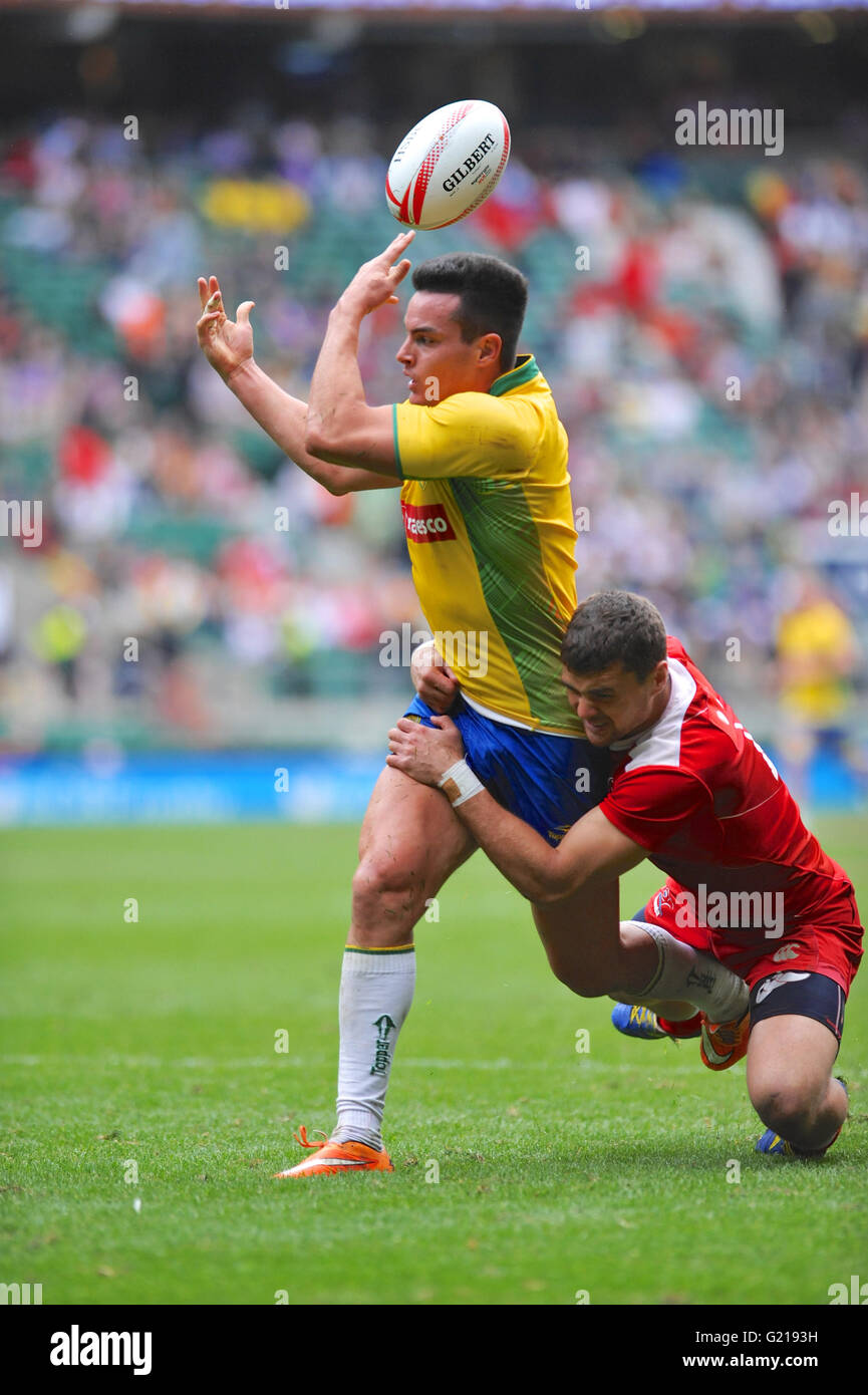 London, UK. 21st May, 2016. Felipe Sancery (BRA) trying to throw the ball backwards to a team mate whilst being tackled by a Russian player during their pool match, HSBC World Rugby Sevens Series, Twickenham Stadium, London, UK. Russia went on to win the match by 14-5. Credit:  Michael Preston/Alamy Live News Stock Photo