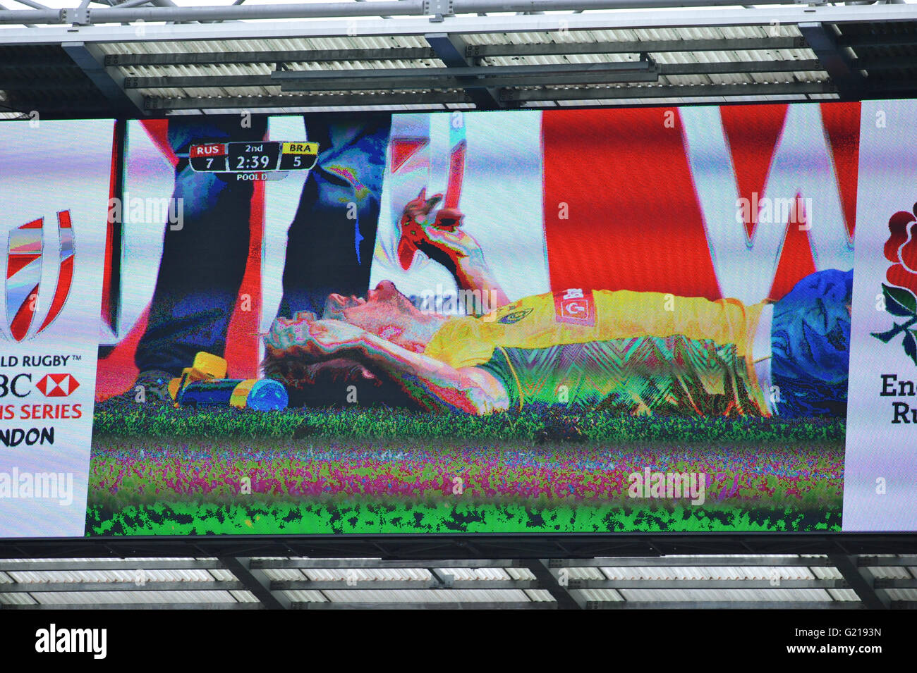 London, UK. 21st May, 2016. Lucas Muller (BRA) lying on the pitch in agony (as seen on a stadium projection screen) after an aggressive tackle in their pool match with Russia, HSBC World Rugby Sevens Series, Twickenham Stadium, London, UK. He was eventually stretchered off the pitch. Russia went on to win the match by 14-5. Credit:  Michael Preston/Alamy Live News Stock Photo