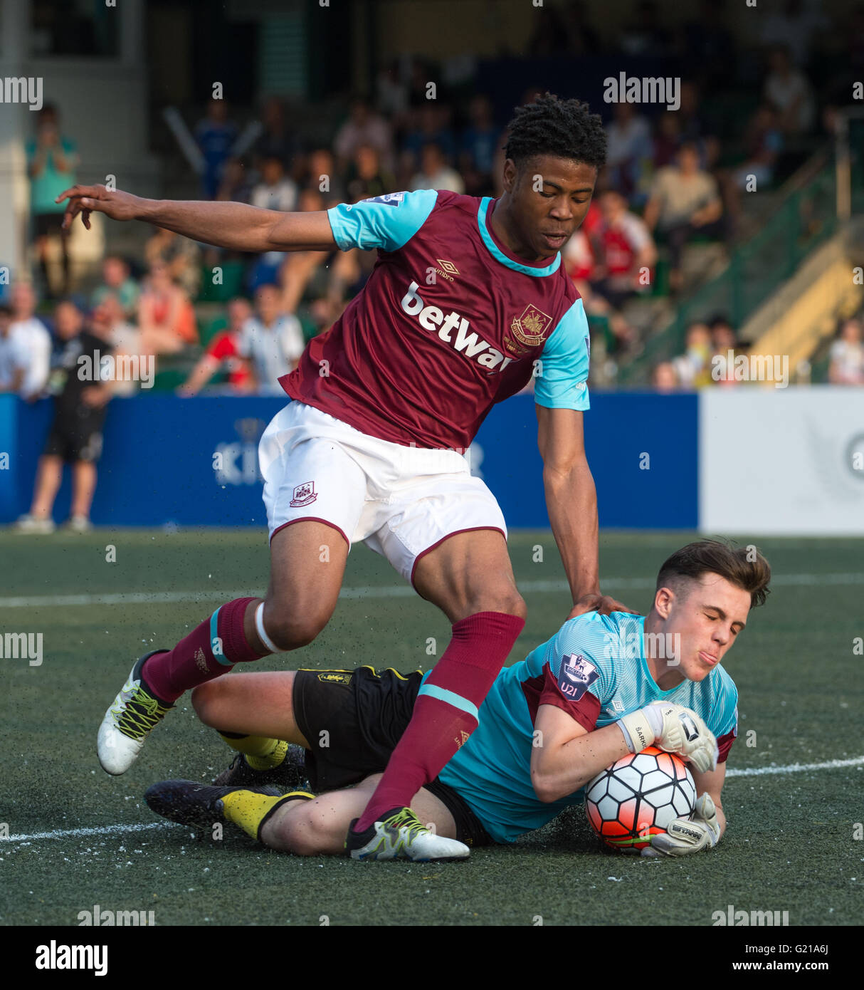 Hong Kong, 22nd May 2016.HKFC Citibank Soccer sevens Cup final Aston Villa vs West Ham United. Aston Villa take the cup. Goalkeeper MATIJA SARKIC is stretchered away after an injury sustained during a great save.He is replaced by MITCH CLARK (Pictured R) who was offered a West Ham United away kit jersey to distinguish him as the goalie for Aston Villa. (L) JAHMAL HECTOR-INGRAM Stock Photo