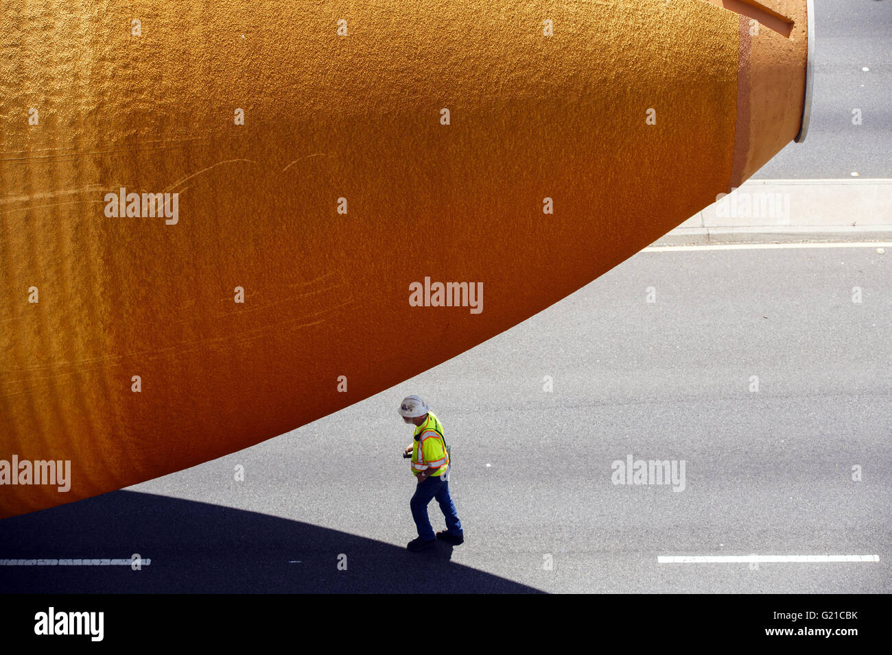 Inglewood, California, USA. 21st May, 2016. A worker walks underneath the ET-94 fuel tank for the Space Shuttle makes its way on Manchester past The Forum from Marina Del Rey to the California Science Center on Saturday, May 21, 2016 in Inglewood, Calif. NASA's last remaining external fuel tank for the Space Shuttle, ET-94, traveled over 16 miles to be united with the Endeavor, where the 66,000 pound fuel tank will be displayed like it is ready to launch. © 2016 Patrick T. Fallon © Patrick Fallon/ZUMA Wire/Alamy Live News Stock Photo