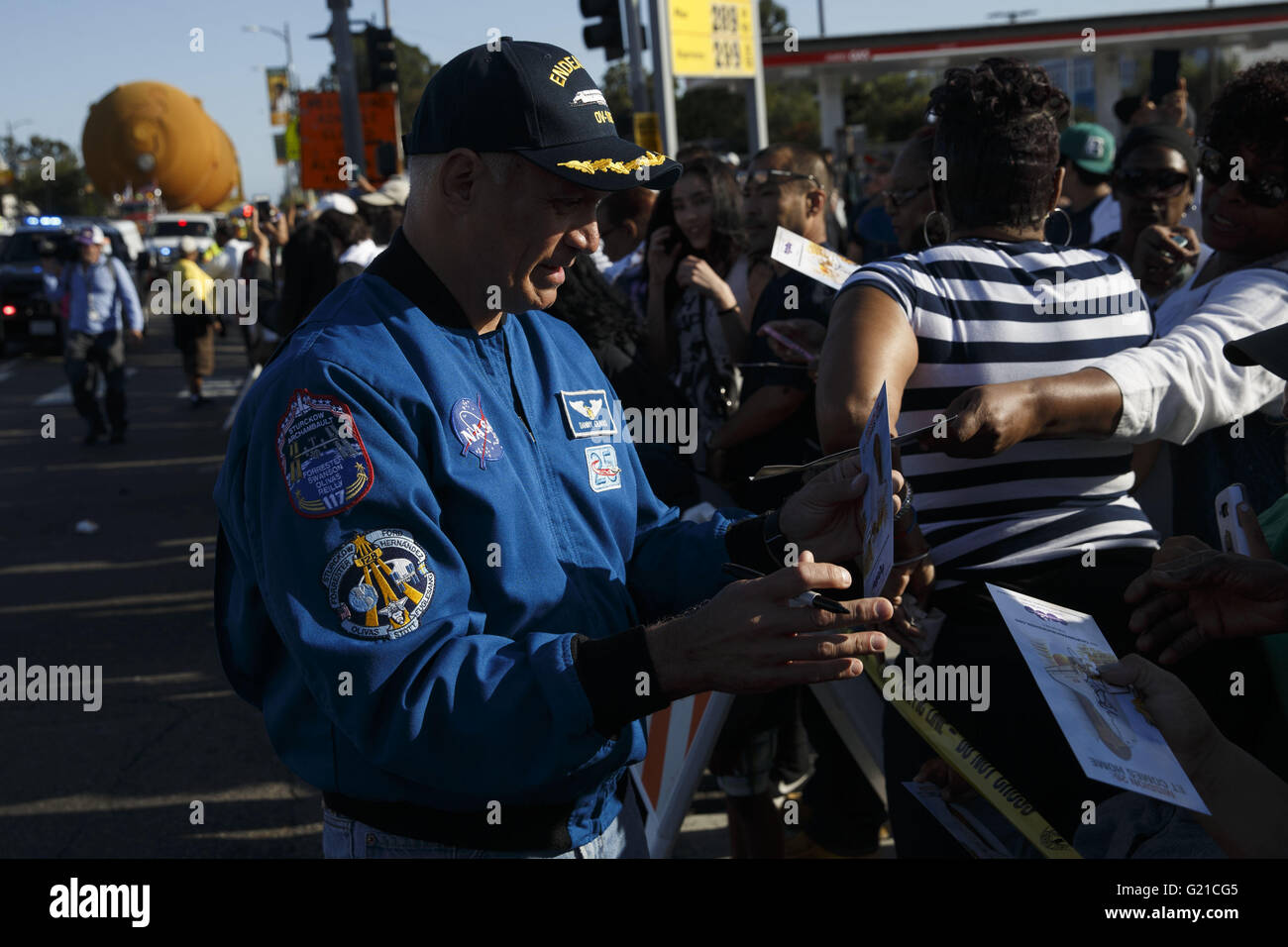 Los Angeles, California, USA. 21st May, 2016. Astronaut John ''Danny'' Olivas signs autographs as the ET-94 fuel tank for the Space Shuttle makes its way up Vermont to the California Science Center on Saturday, May 21, 2016 in Los Angeles, Calif. NASA's last remaining external fuel tank for the Space Shuttle, ET-94, traveled over 16 miles to be united with the Endeavor, where the 66,000 pound fuel tank will be displayed like it is ready to launch. © 2016 Patrick T. Fallon © Patrick Fallon/ZUMA Wire/Alamy Live News Stock Photo