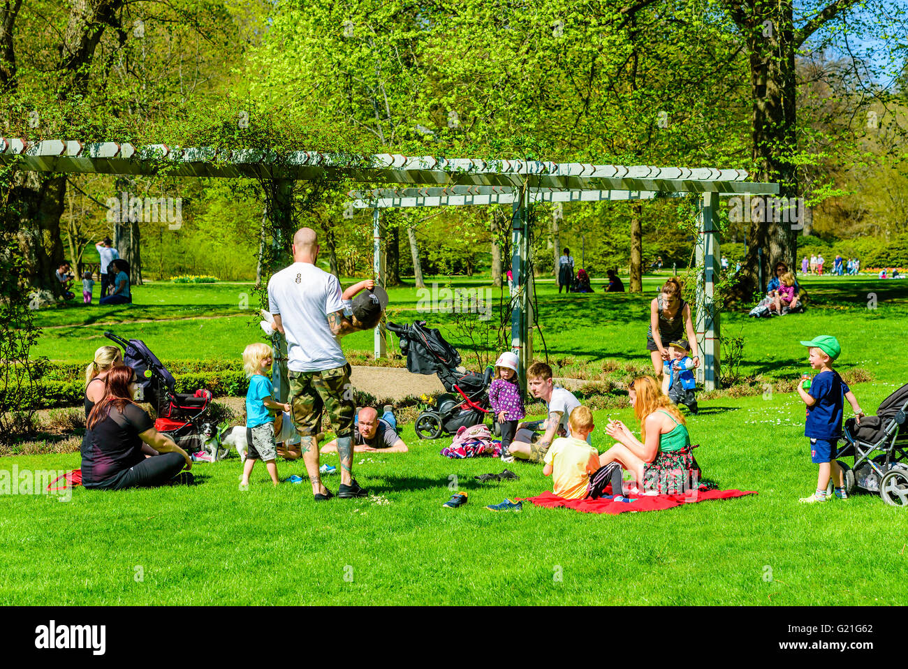 Ronneby, Sweden - May 8, 2016: People enjoying the fine weather while relaxing in the park. Young adults and children playing an Stock Photo