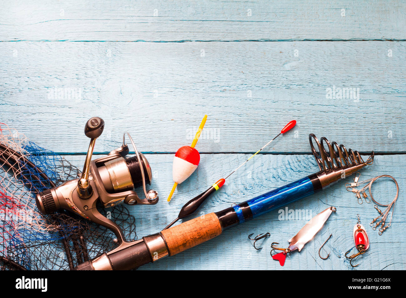 Fishing tackle on wooden blue background closeup Stock Photo - Alamy