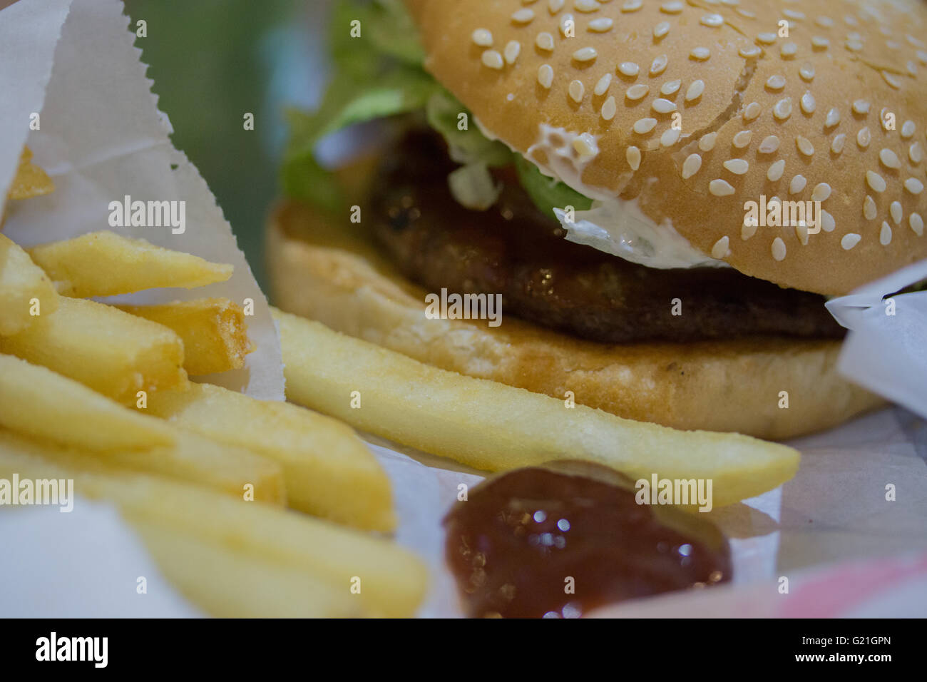 Burger meal accompanied  with fries and tomato ketchup. Stock Photo