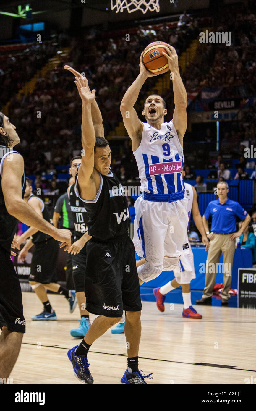 Carlos Rivera ( R ), player of Puerto Rico, shoots the ball over defender  Carlos Prigioni (L), player of Argentina, during FIBA Basketball World Cup  2014 Group Phase match, played at Municipal