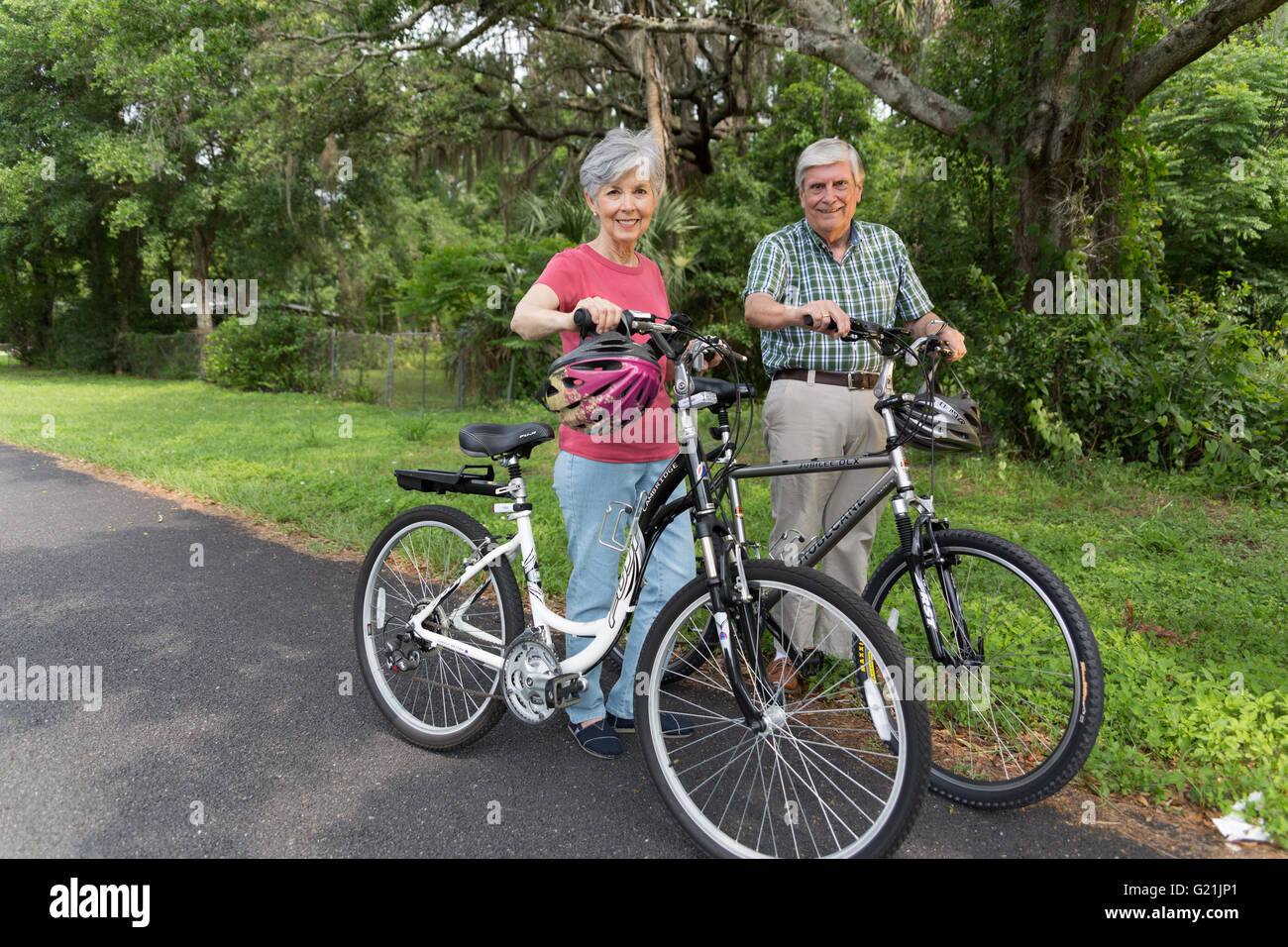 Active Senior couple riding bicycles Stock Photo