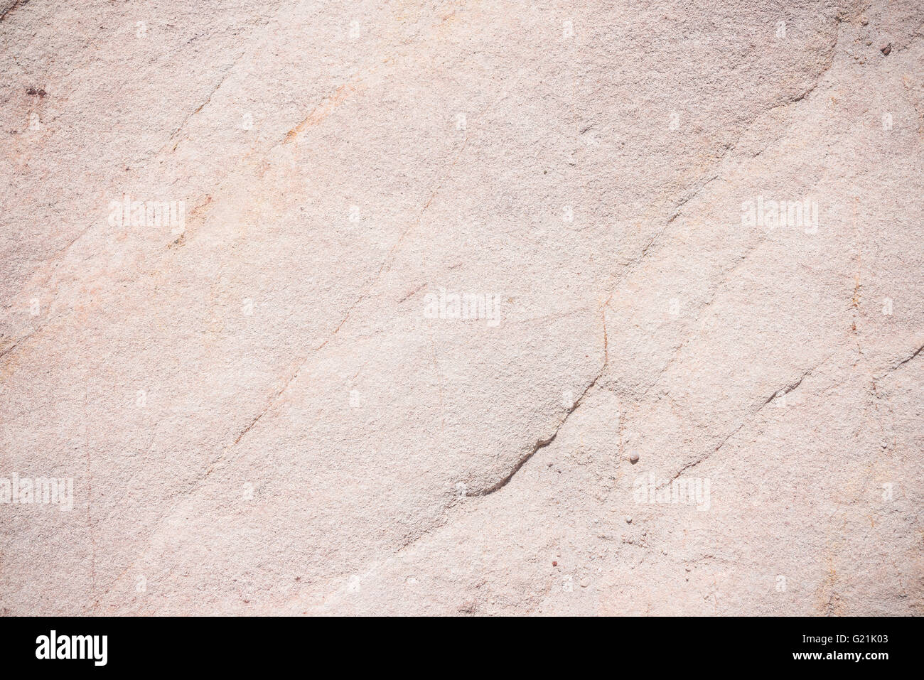 Sedimentary rock, fine grained omogeneous sandstone, with fractures and alteration pattern. Natural background, pattern and text Stock Photo