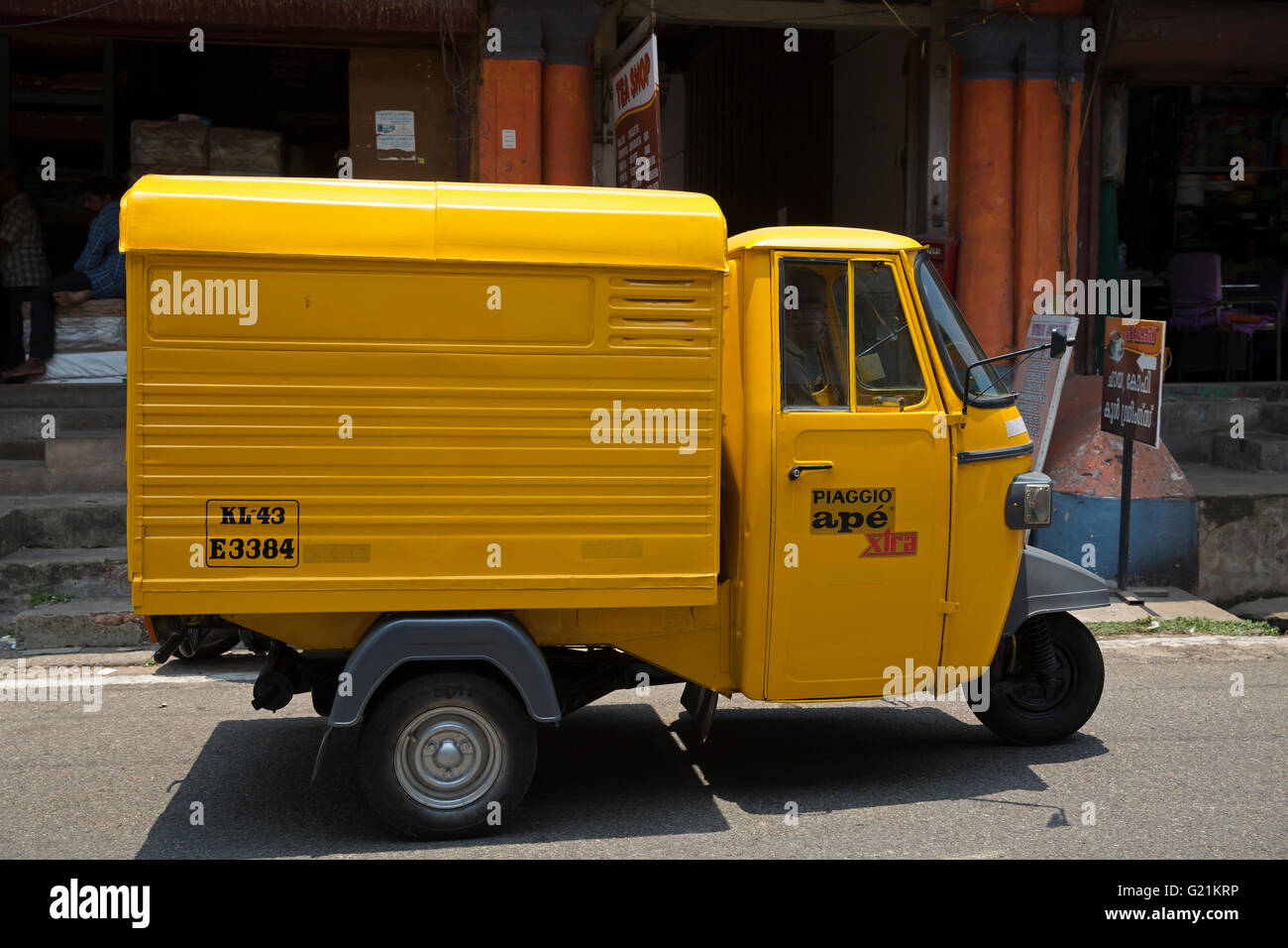 A three wheeler mini yellow van in Cochin India Stock Photo