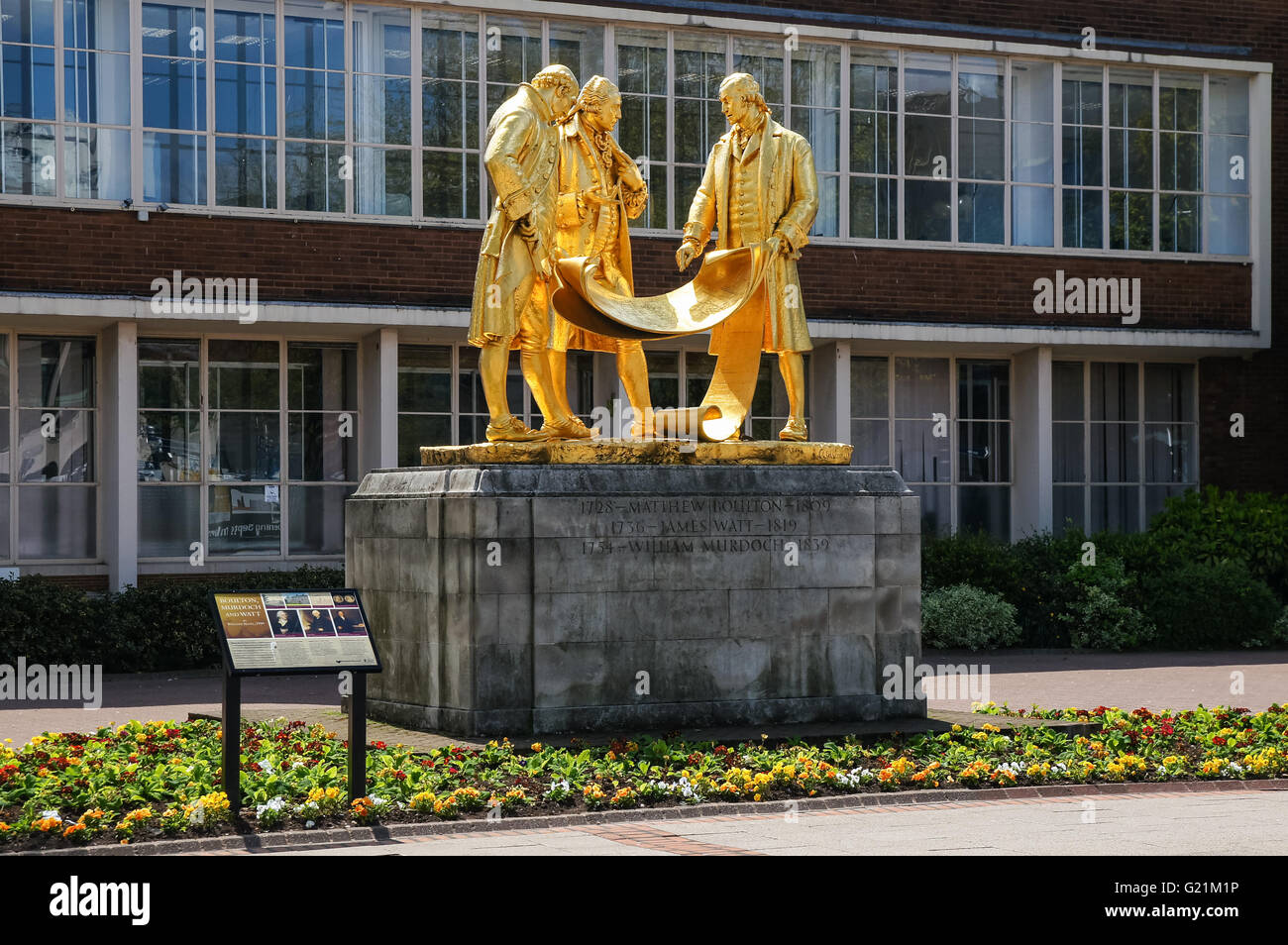 The gilded bronze statue of Matthew Boulton, James Watt and William Murdoch by William Bloye on Broad Street in Birmingham, UK Stock Photo