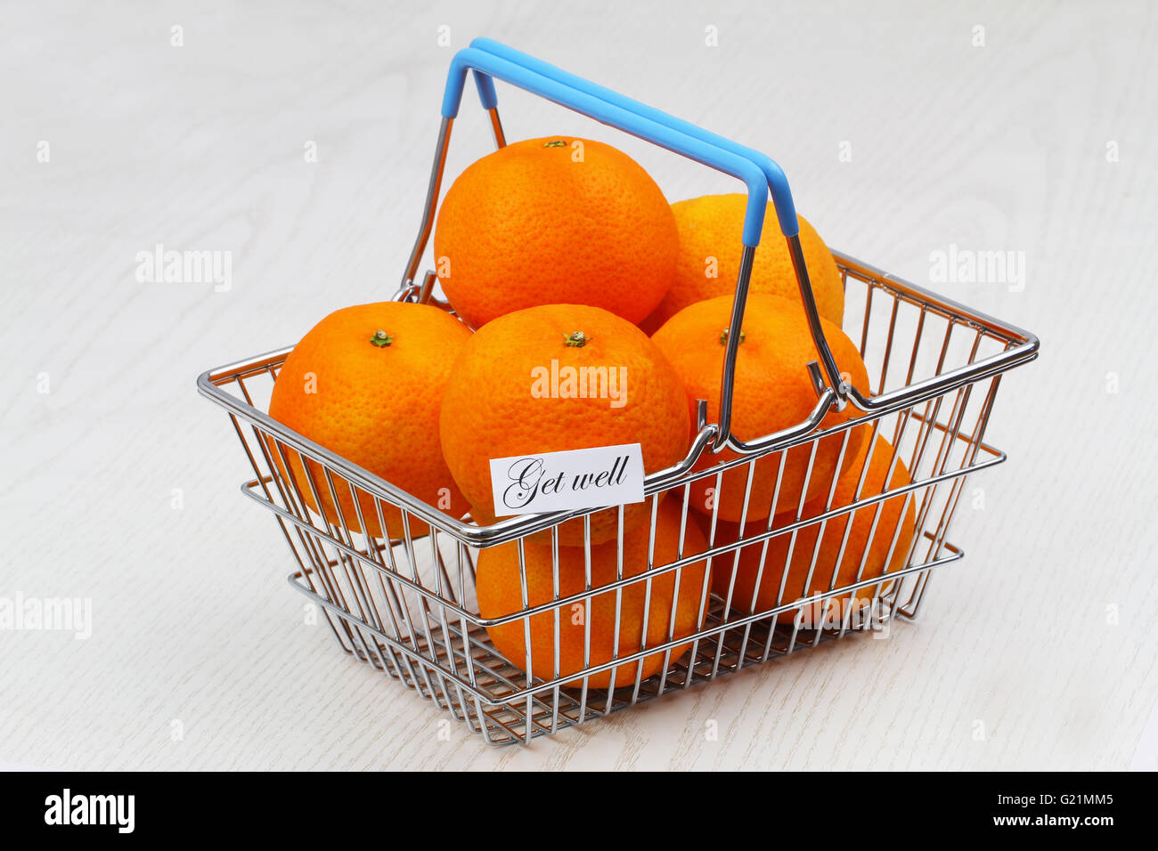 Get well card with miniature shopping basket full of mandarines Stock Photo