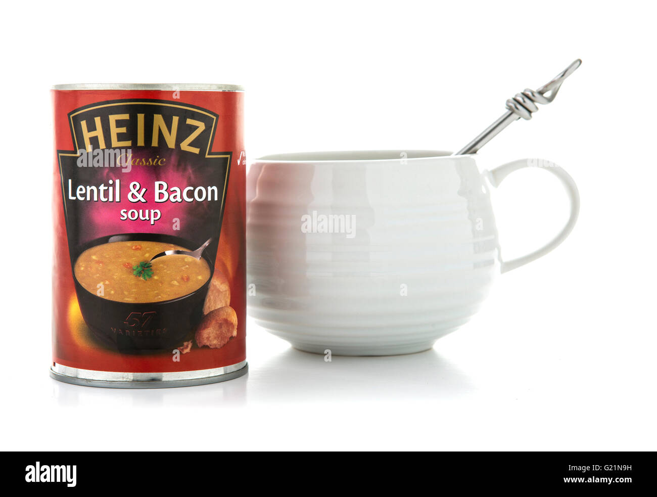 Heinz lentil and Bacon soup with bowl and spoon on a white background Stock Photo