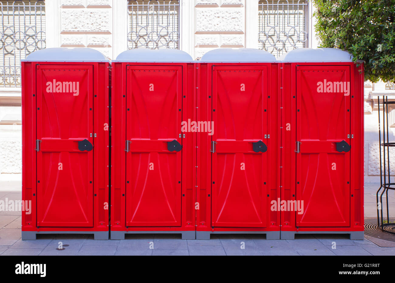 View of row of red portable toilets Stock Photo Alamy