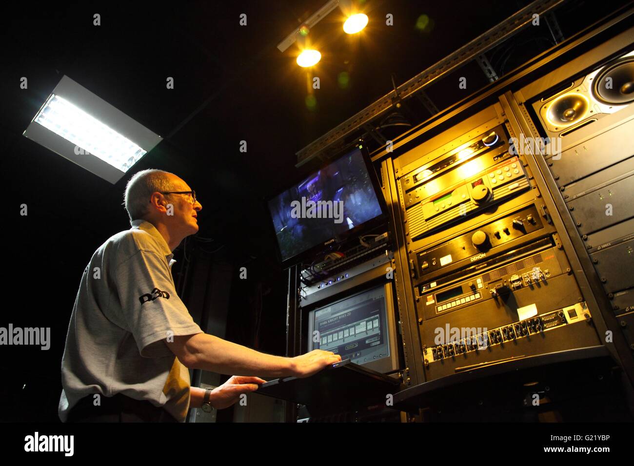 A man at the controls of a Giant Screen Cinema in Millennium Point, Birmingham Stock Photo