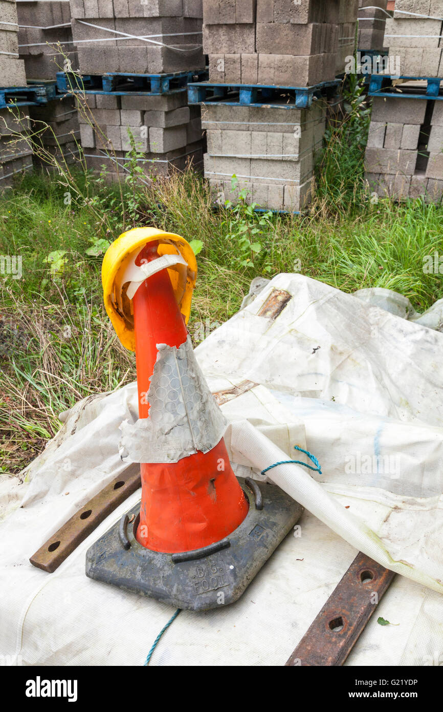 Safety helmet and traffic cone on a construction site, England, UK Stock Photo