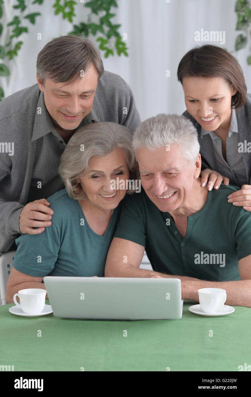 Happy smiling family with laptop Stock Photo - Alamy