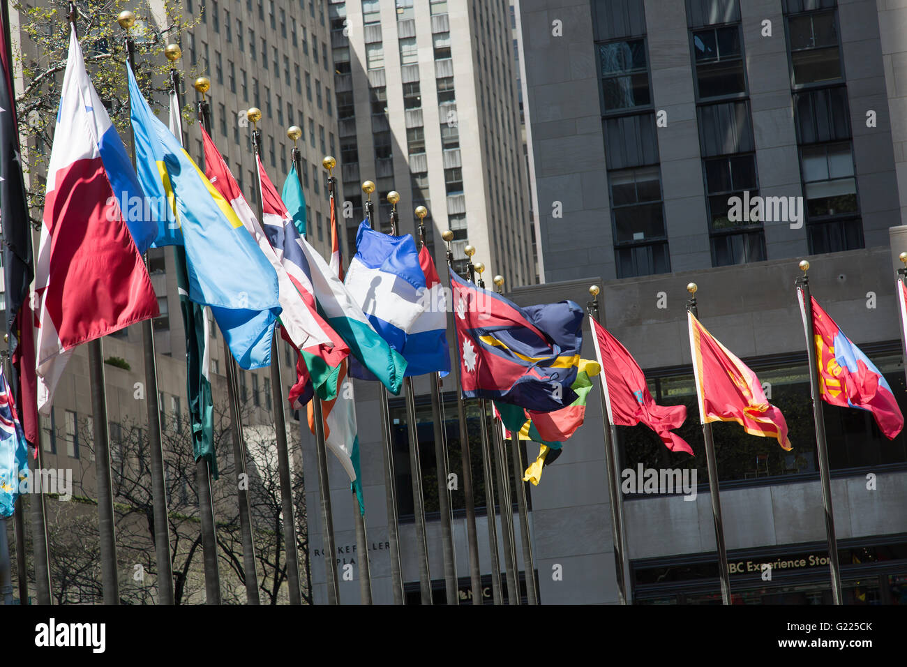 NEW YORK, USA - APRIL 21, 2016: Flagpoles display flags of United Nations member countries around the Rockefeller plaza. There a Stock Photo